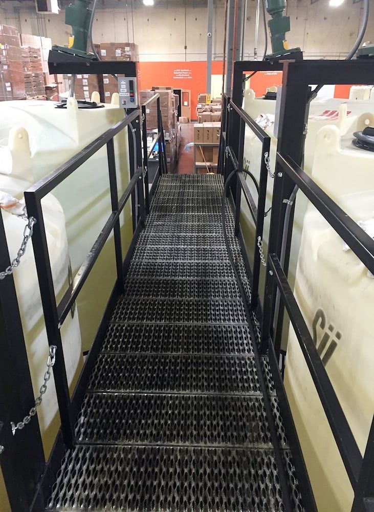 Industrial walkway with custom welded steel grating and railing system