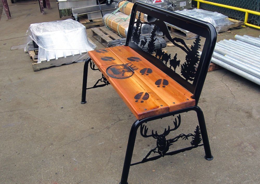 Custom fabricated steel bench with decorative cut-out metal design