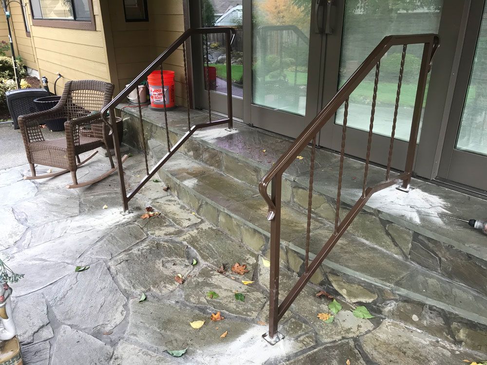 Residential concrete steps with custom welded steel handrail system