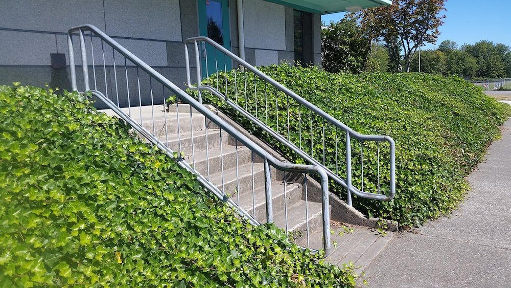 Residential deck stairs with custom welded steel cable railing system