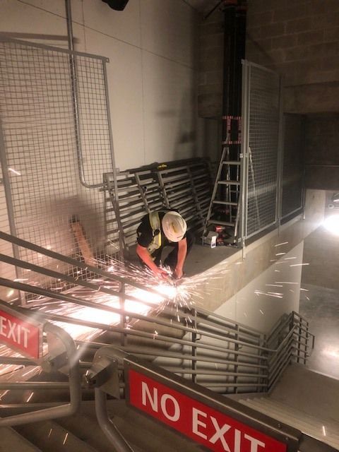 On-site welding repair of metal railing with active arc welding and sparks