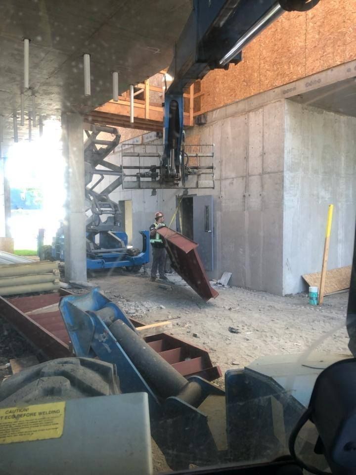 Equipment positioned for structural steel installation inside concrete structure