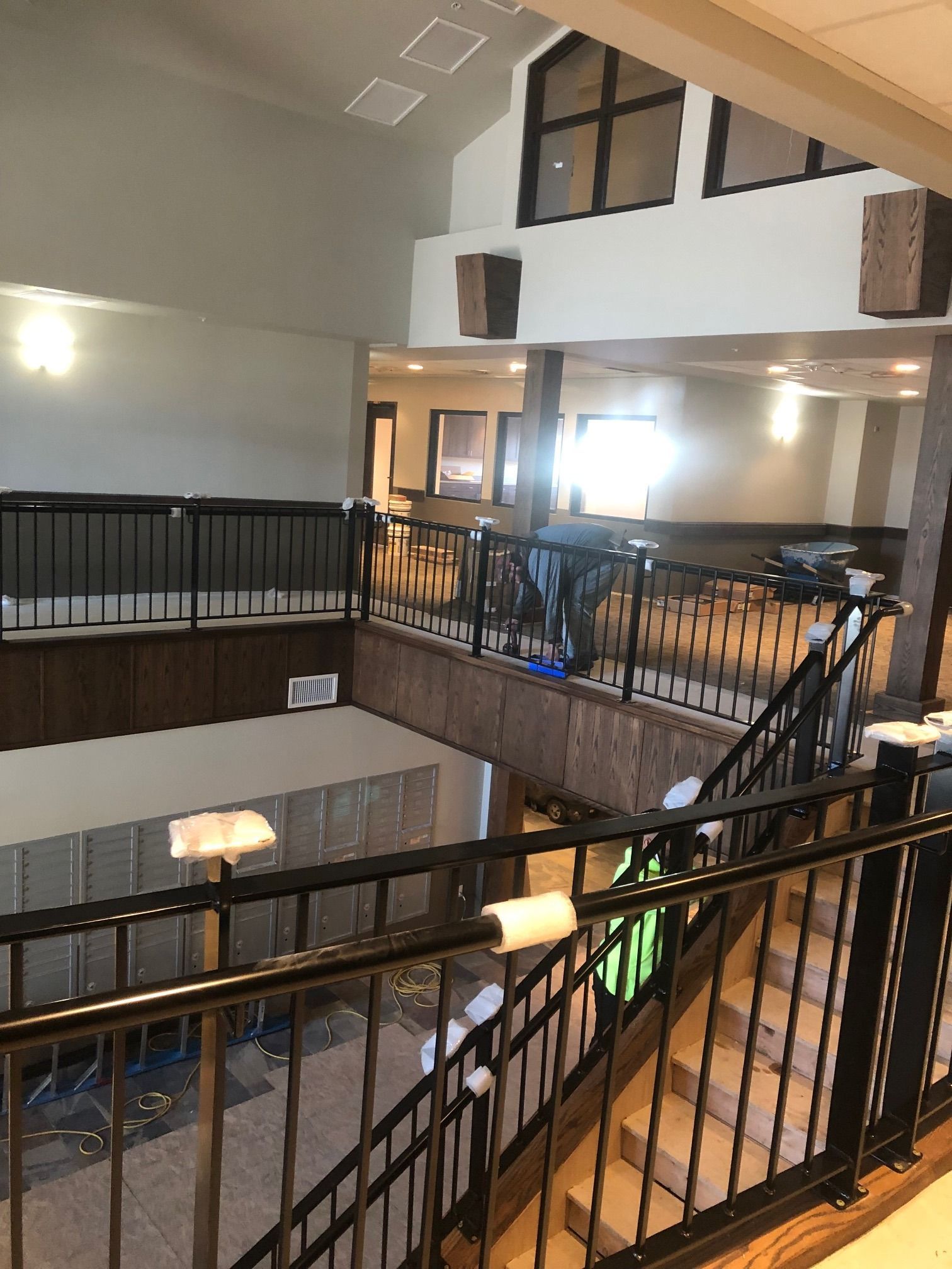 Interior commercial metal railing installation overlooking mezzanine