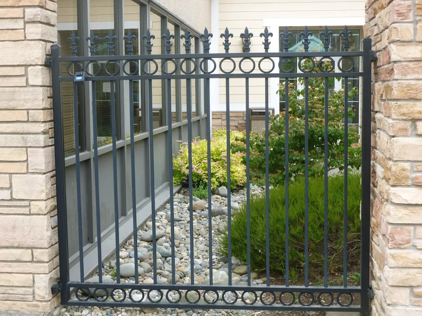 Decorative custom welded steel gate with vertical baluster design