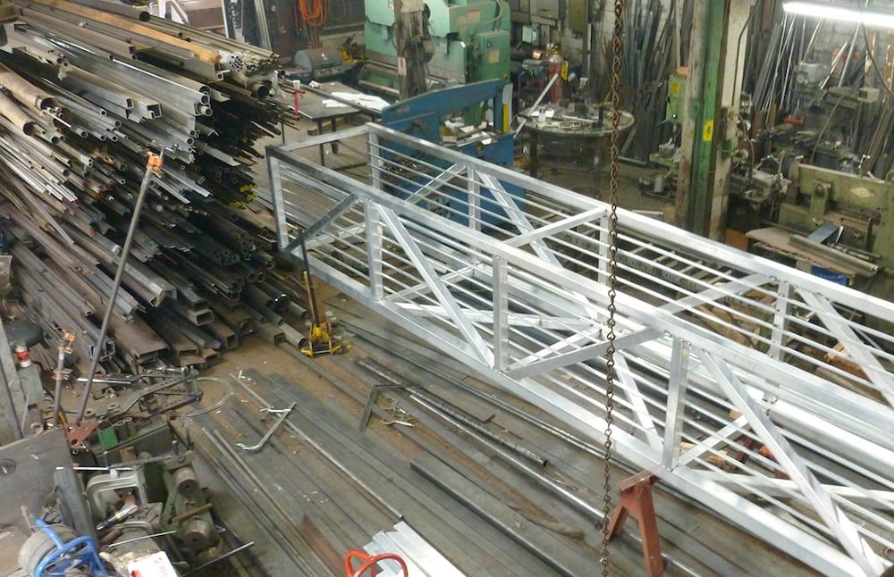 Custom fabricated structural steel components prepared for installation in shop