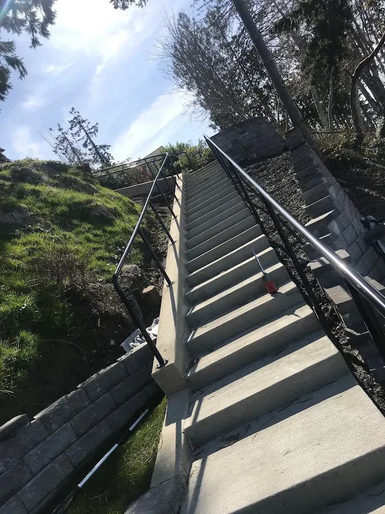 Outdoor hillside staircase with custom welded steel railing system