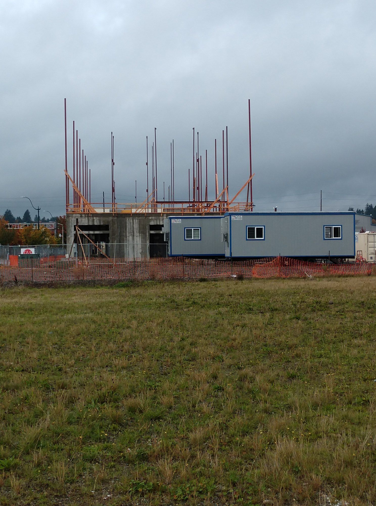 Structural steel framing installation on commercial building with vertical support columns