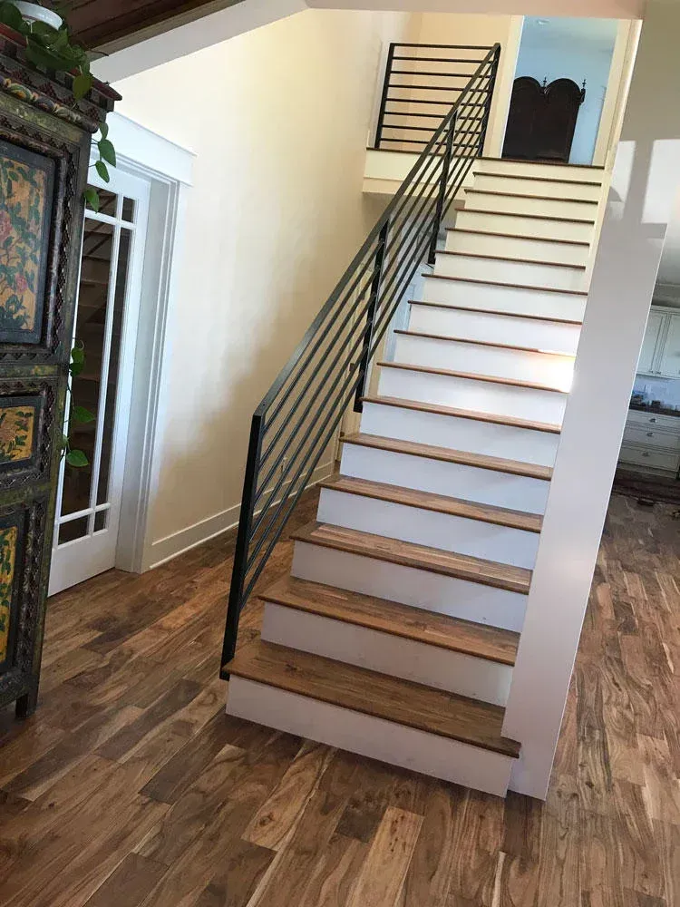 Interior staircase with custom welded steel railing and wood steps