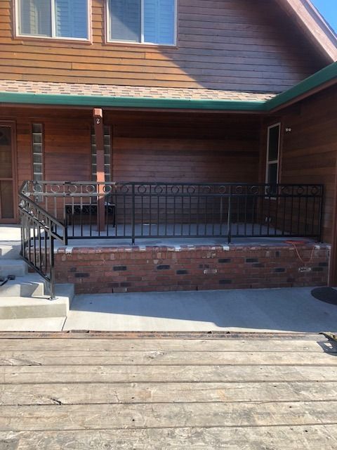 Custom welded steel porch railing on residential home entrance