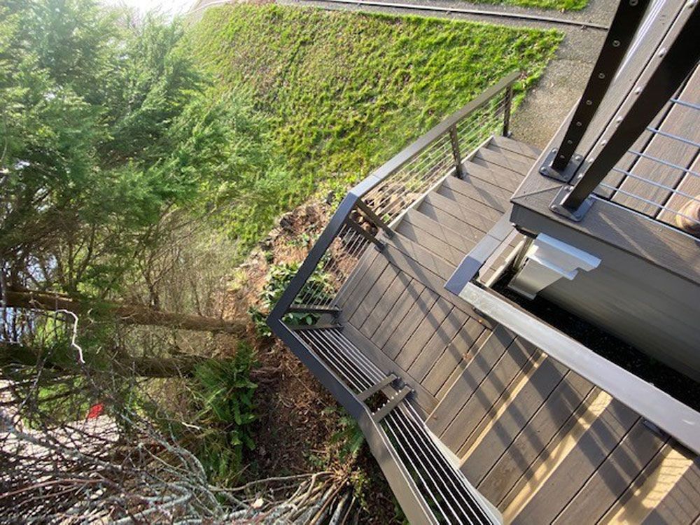 Elevated outdoor walkway with custom welded steel railing system