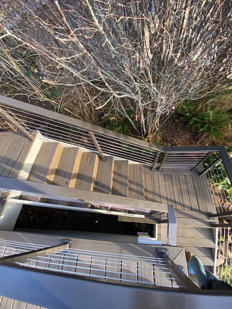 Outdoor stairwell with custom welded steel railing system and landings