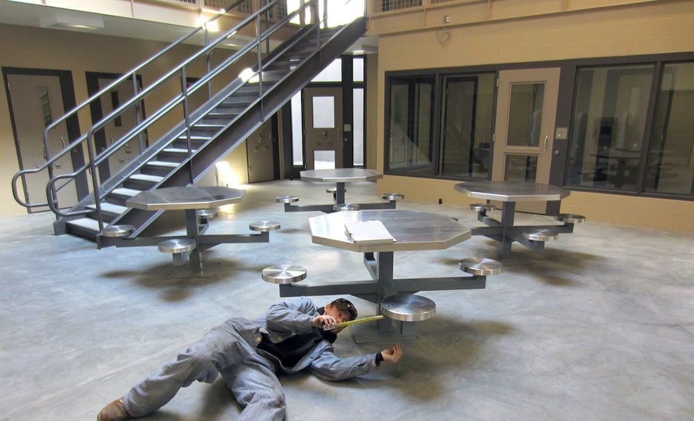 On-site welding of steel seating installation in correctional facility