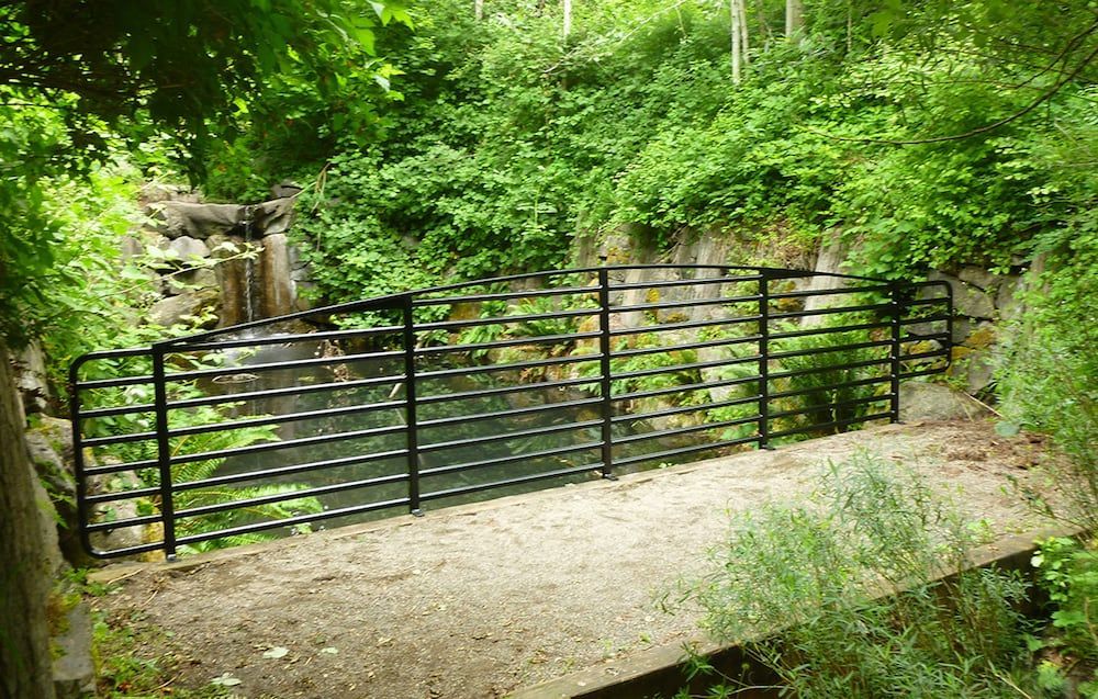 Outdoor pathway with custom welded steel horizontal railing system