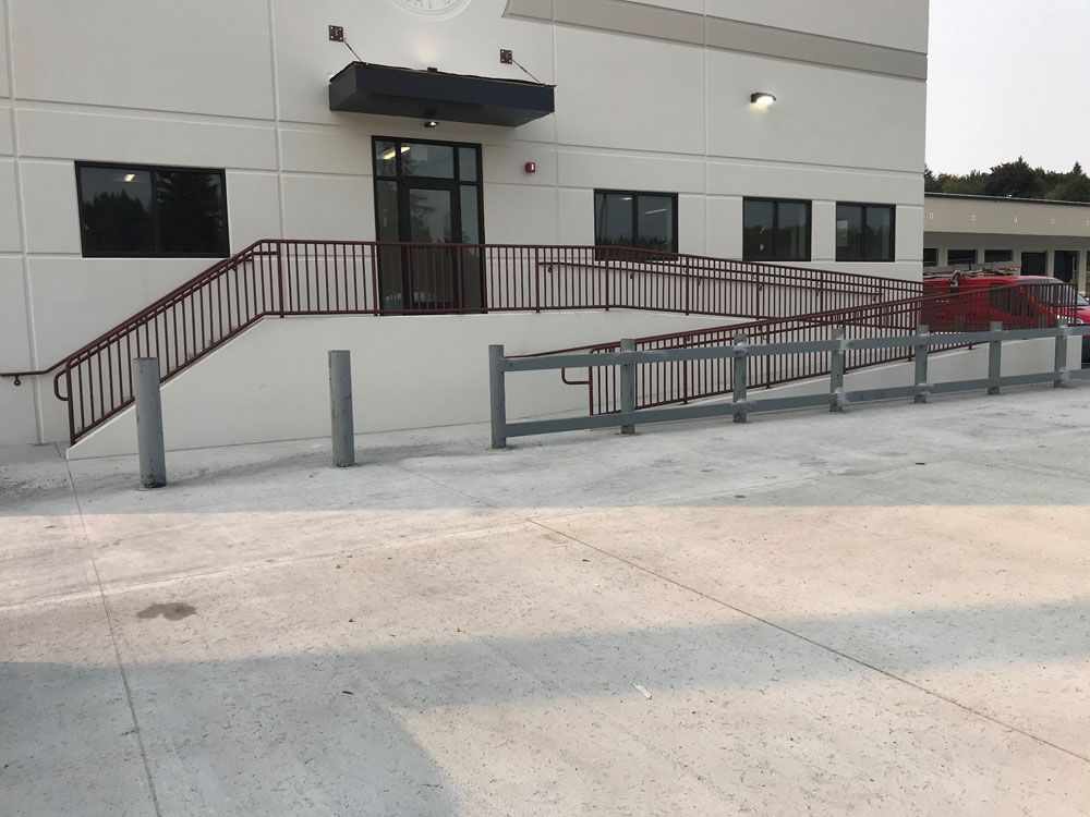 Commercial building ADA ramp with custom welded steel railing system