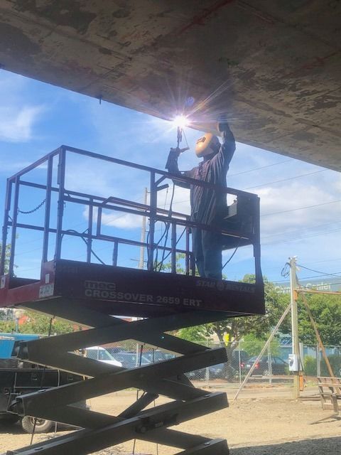 Field welding repair on structural steel using lift equipment for overhead work
