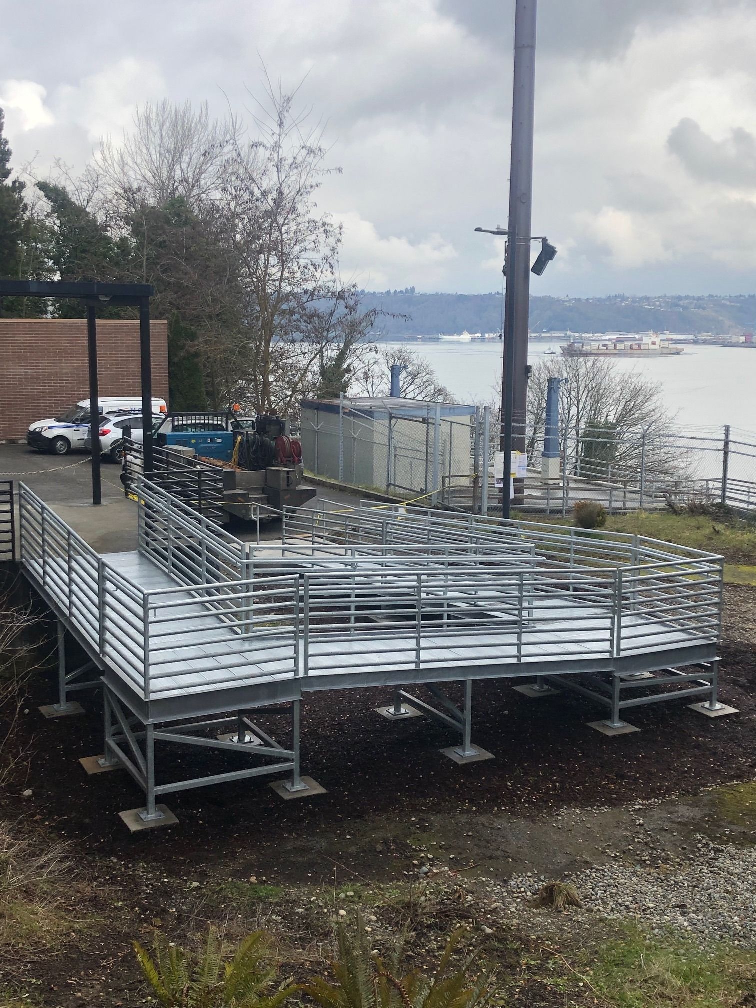 Custom welded steel walkway with railing system overlooking waterfront