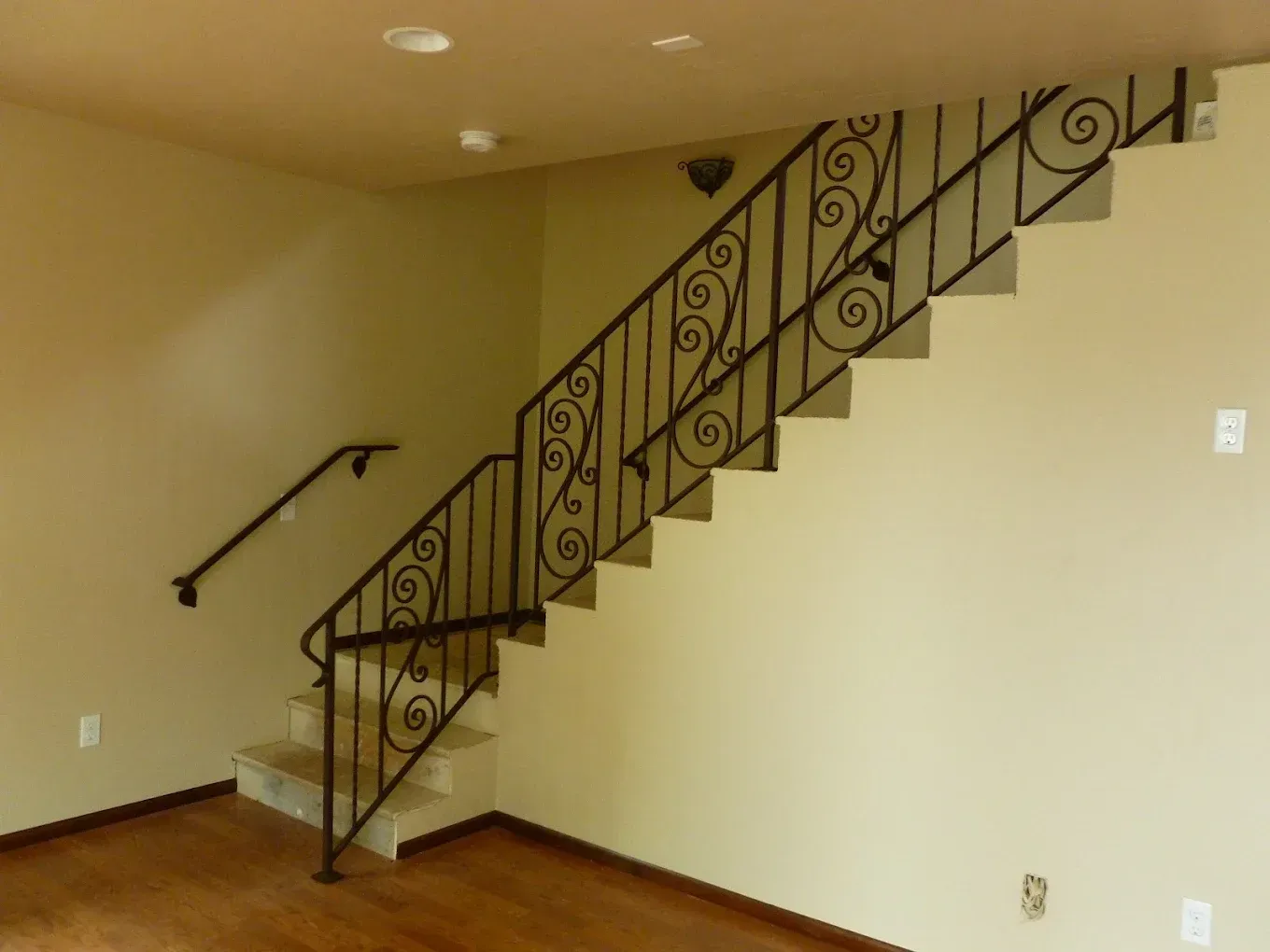 Decorative indoor wrought iron staircase railing with scrollwork