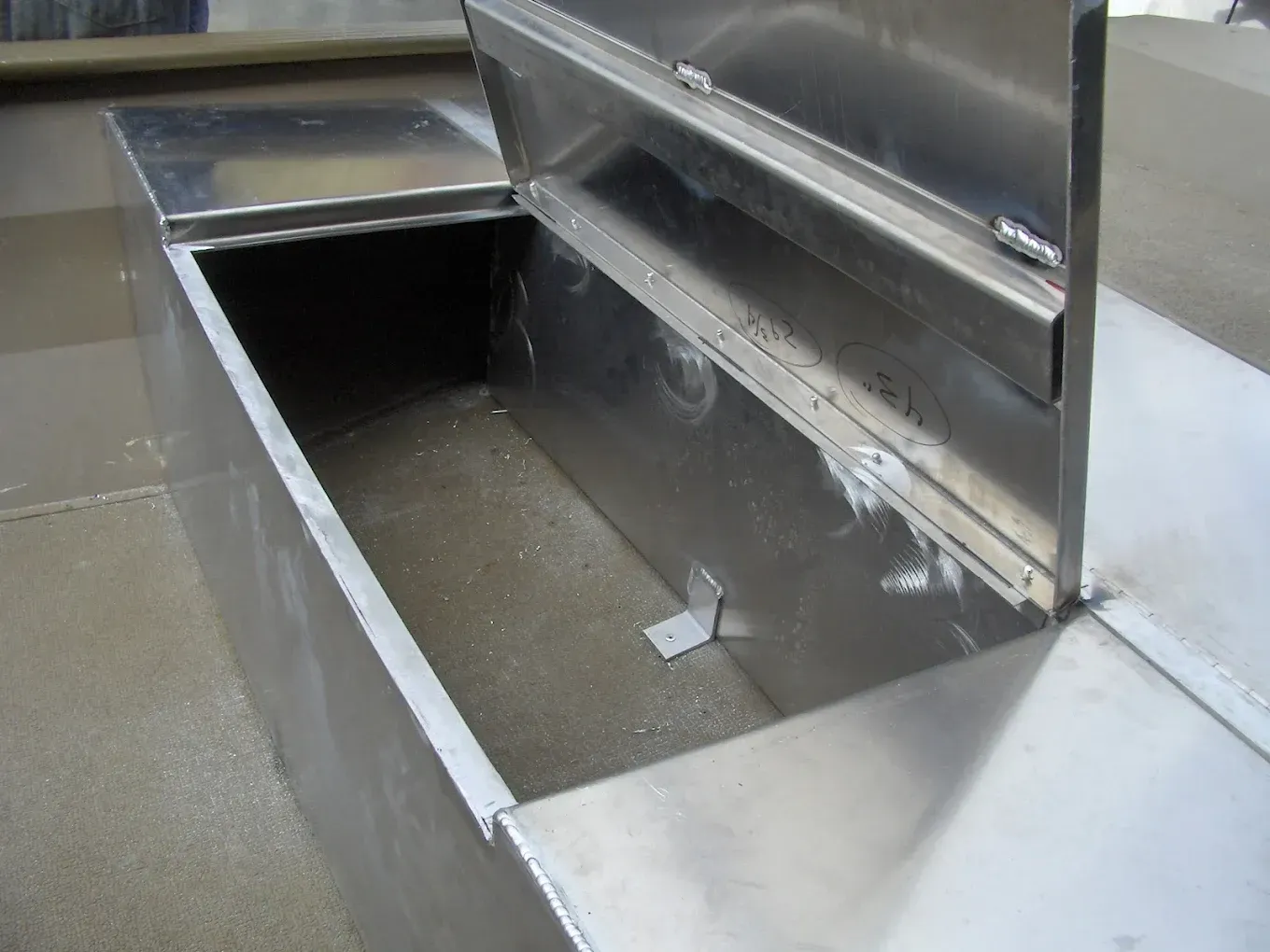 Open stainless steel containment box with hinged access lid