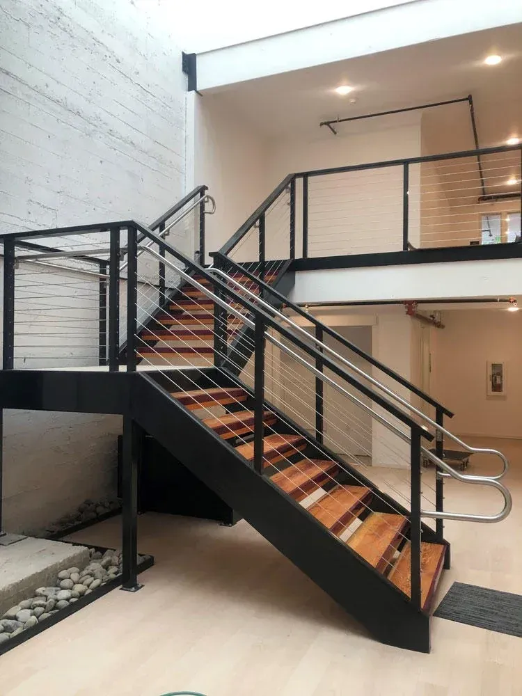 Commercial interior metal staircase with modern welded steel railings