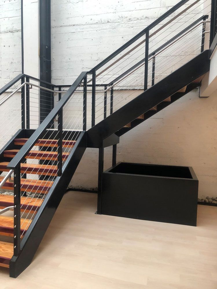 Industrial-style metal staircase with welded steel handrails and steps