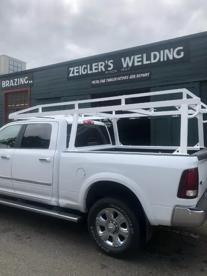 Custom fabricated steel rack installed on work truck for utility use