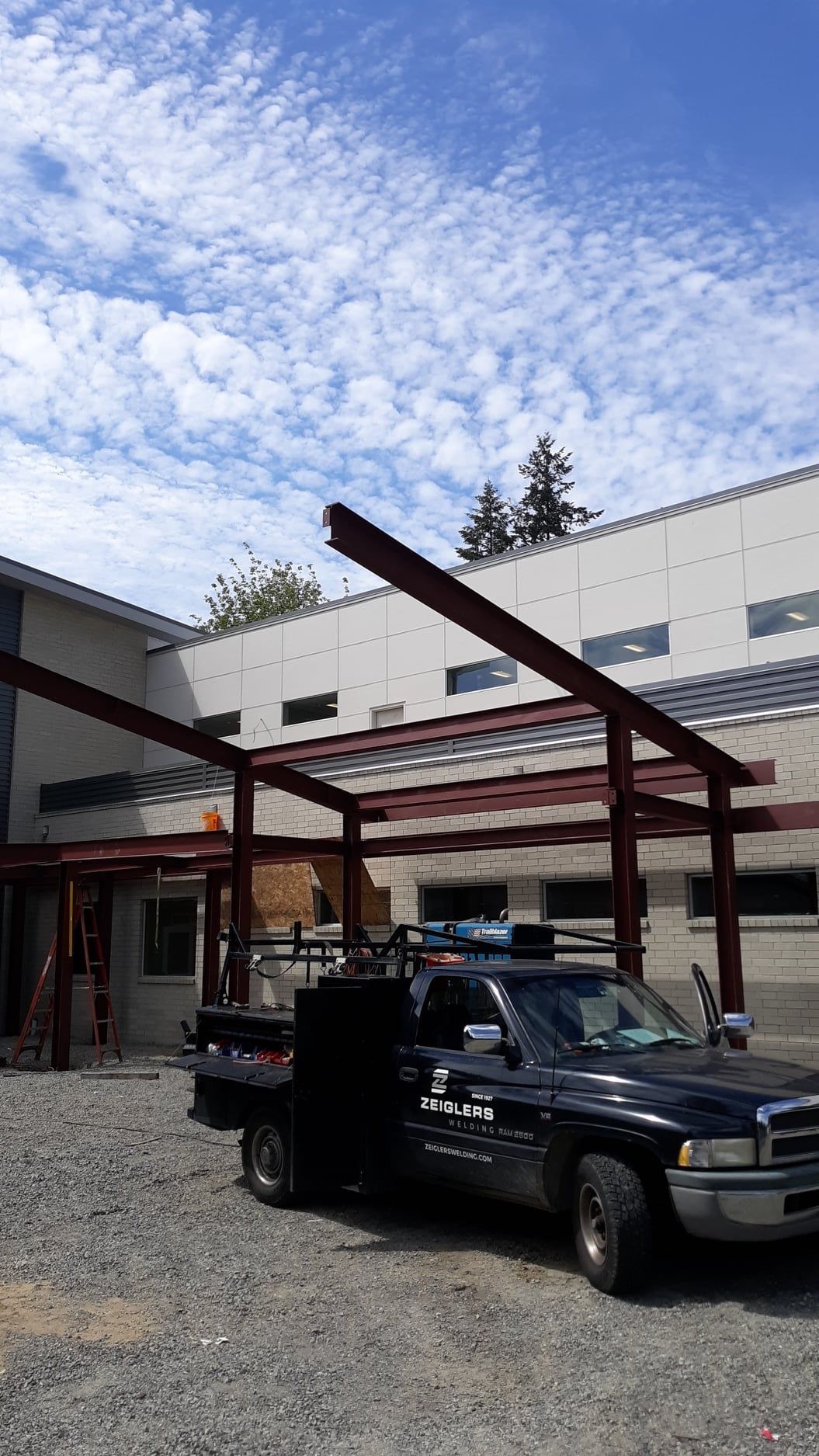 Structural steel canopy frame installed over commercial entrance