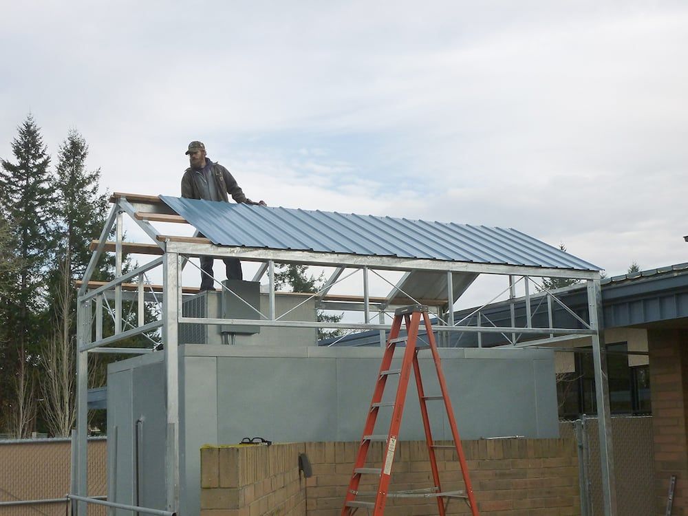 Field installation of custom fabricated steel roof structure