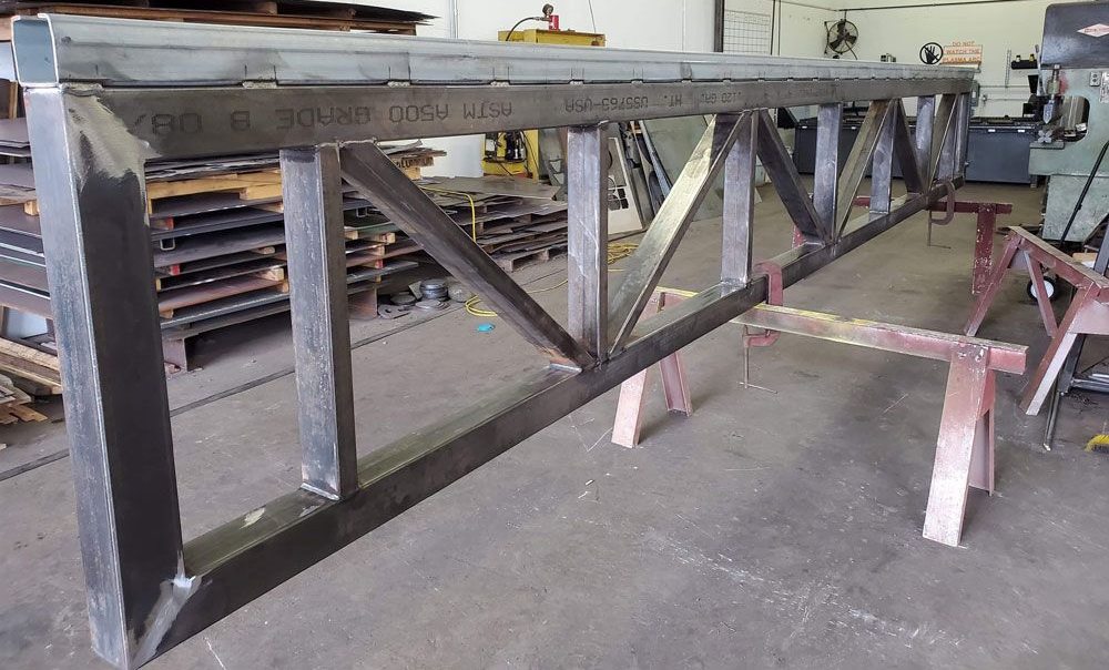 Fabricated structural steel beam assembly in workshop