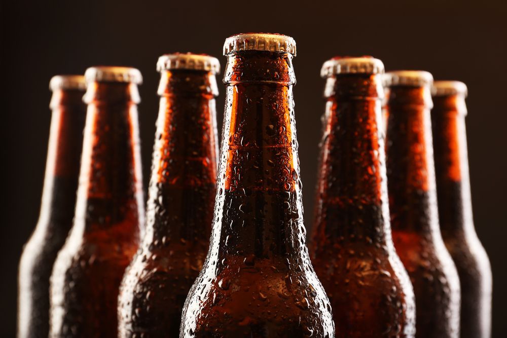 Six Brown Beer Bottles With Condensation, Dark Background — BYO Cellars in Anna Bay, NSW