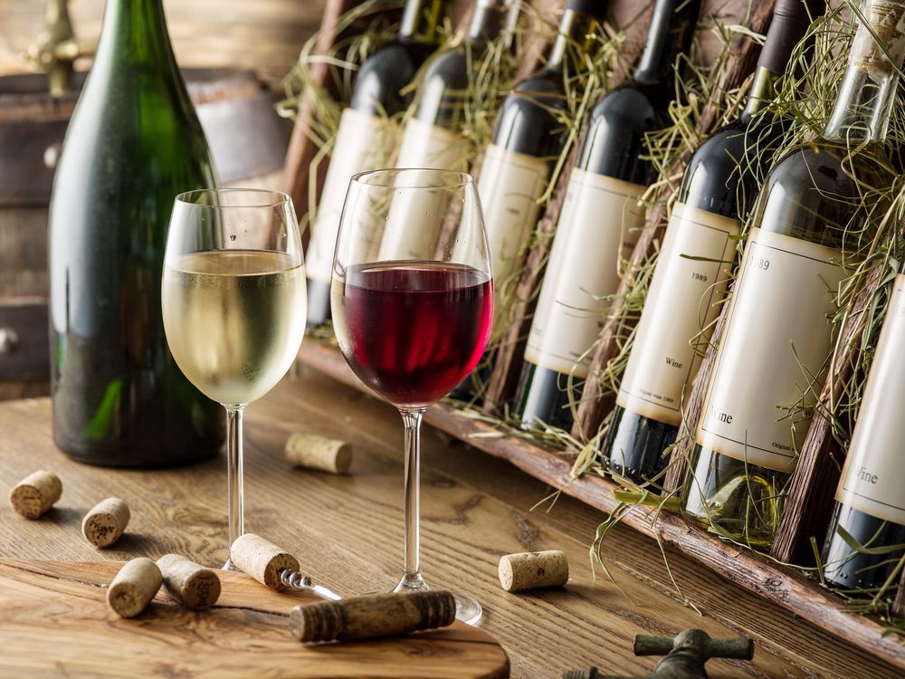 Wine Glasses With White and Red Wine, Wine Bottles in a Wooden Crate — BYO Cellars in Coffs Harbour, NSW