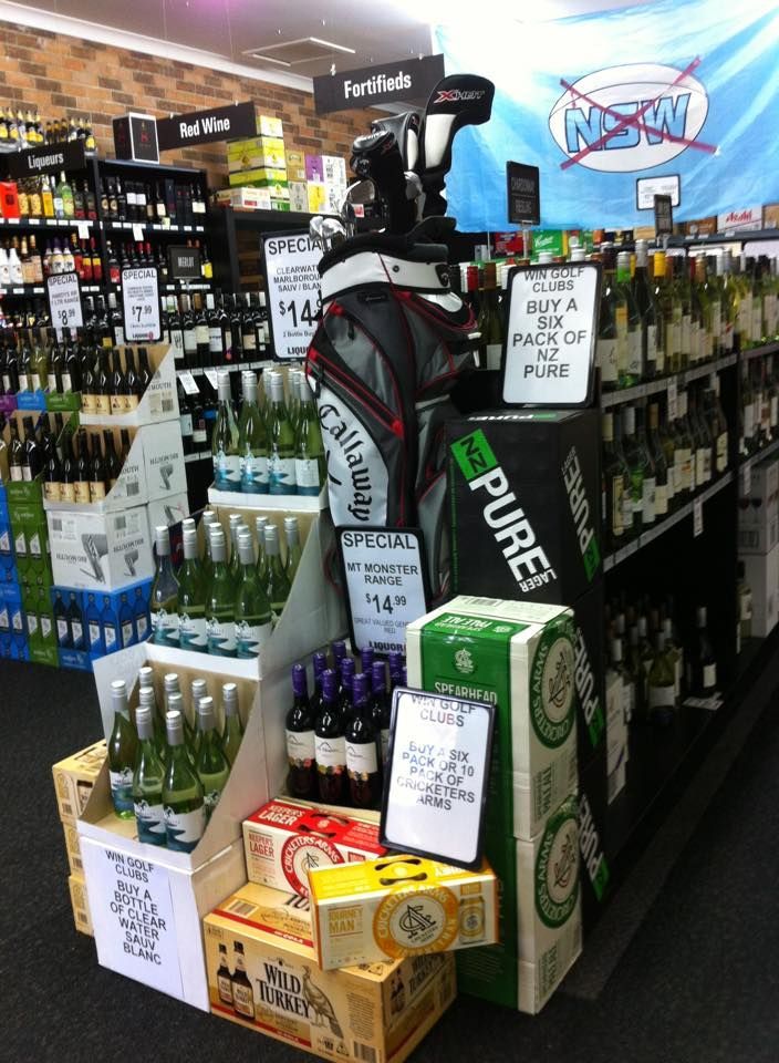 Liquor Store Display With Golf Bag, Bottles, and Boxes of Alcohol — BYO Cellars in Budgewoi, NSW