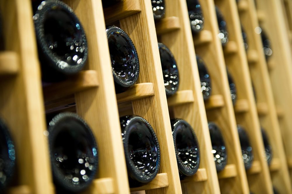 Wine Bottles Stored in a Wooden Rack, Angled Perspective — BYO Cellars in Coffs Harbour, NSW