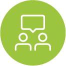 Green circle icon with white speech bubbles above two people, representing a conversation or discussion.