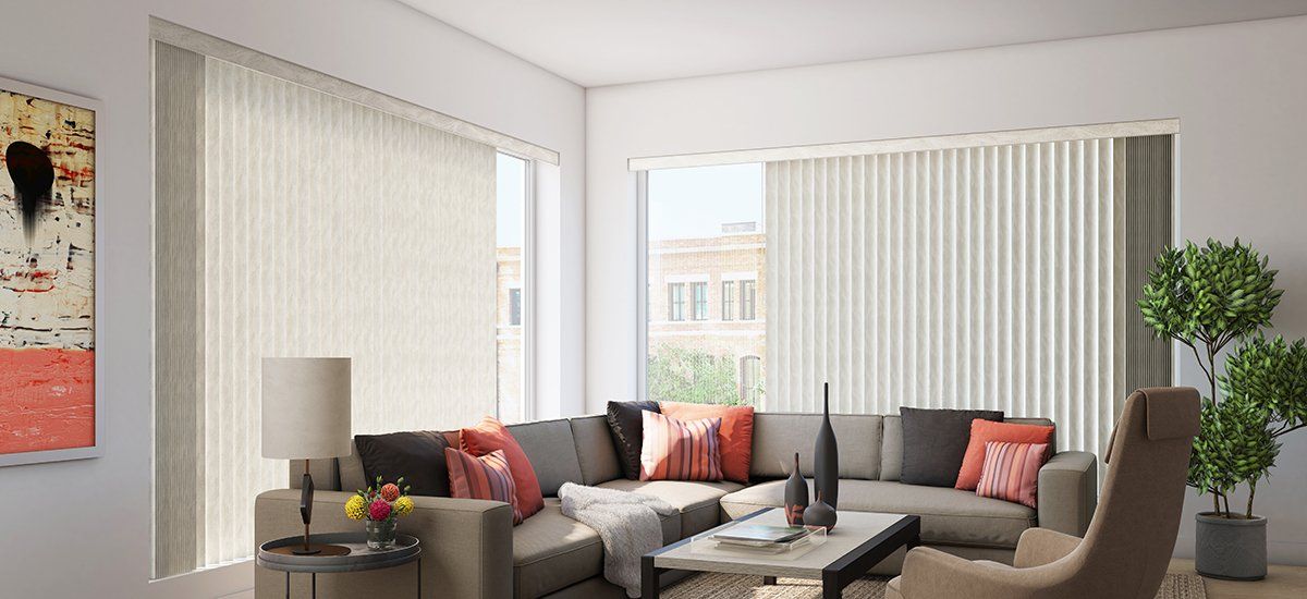 A living room with a couch , chair , table and blinds.