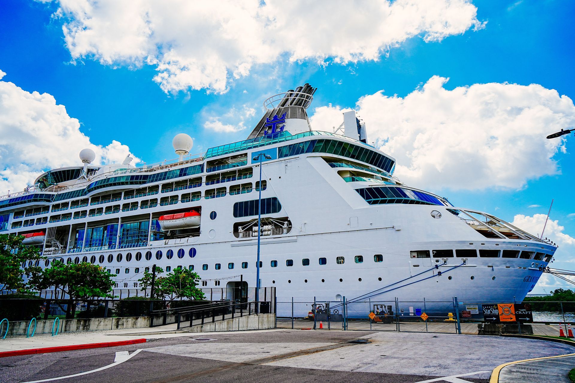 A large cruise ship is docked in a harbor in Florida