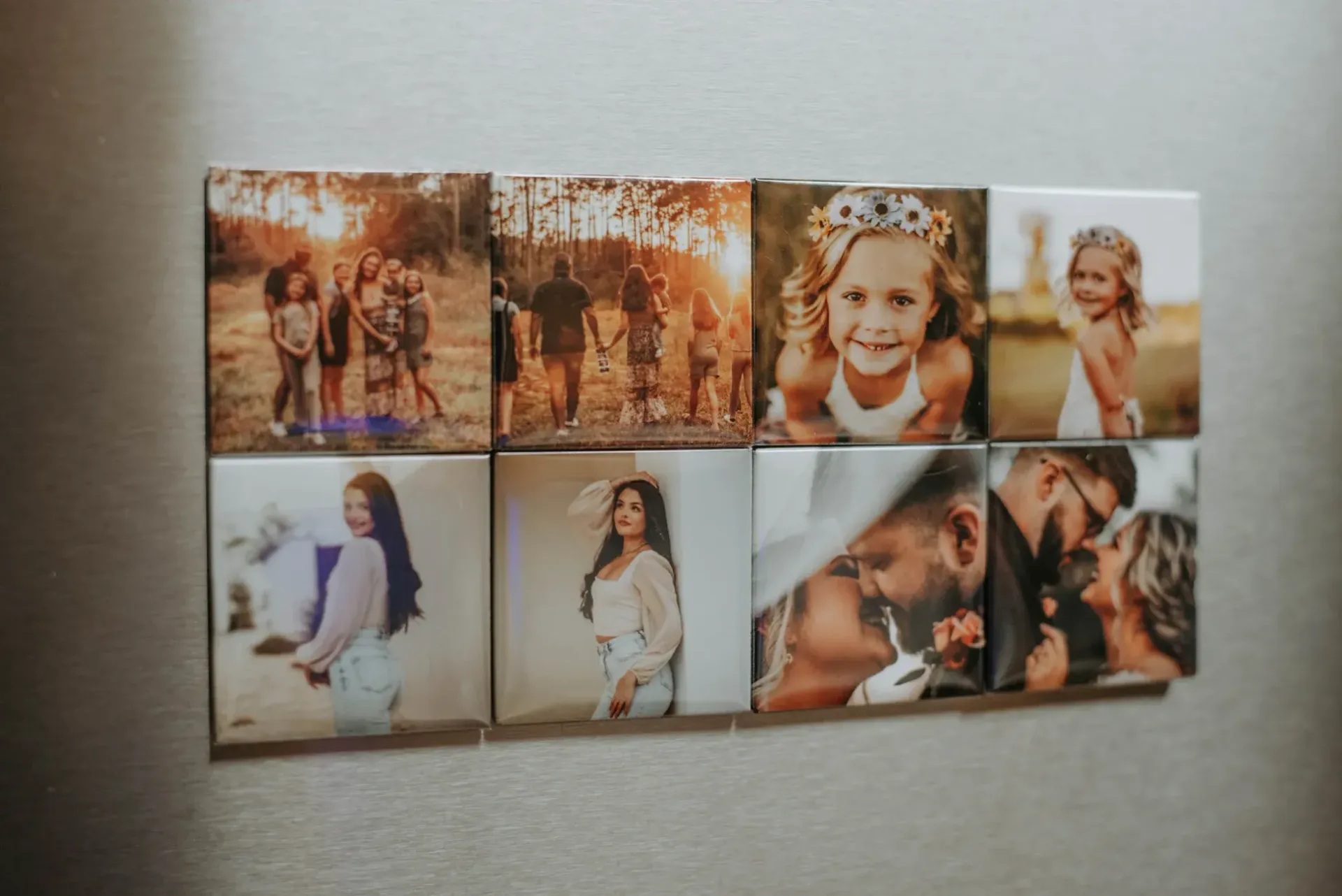 Photos on a wall: families, children, and couples, displayed as square tiles in warm tones.