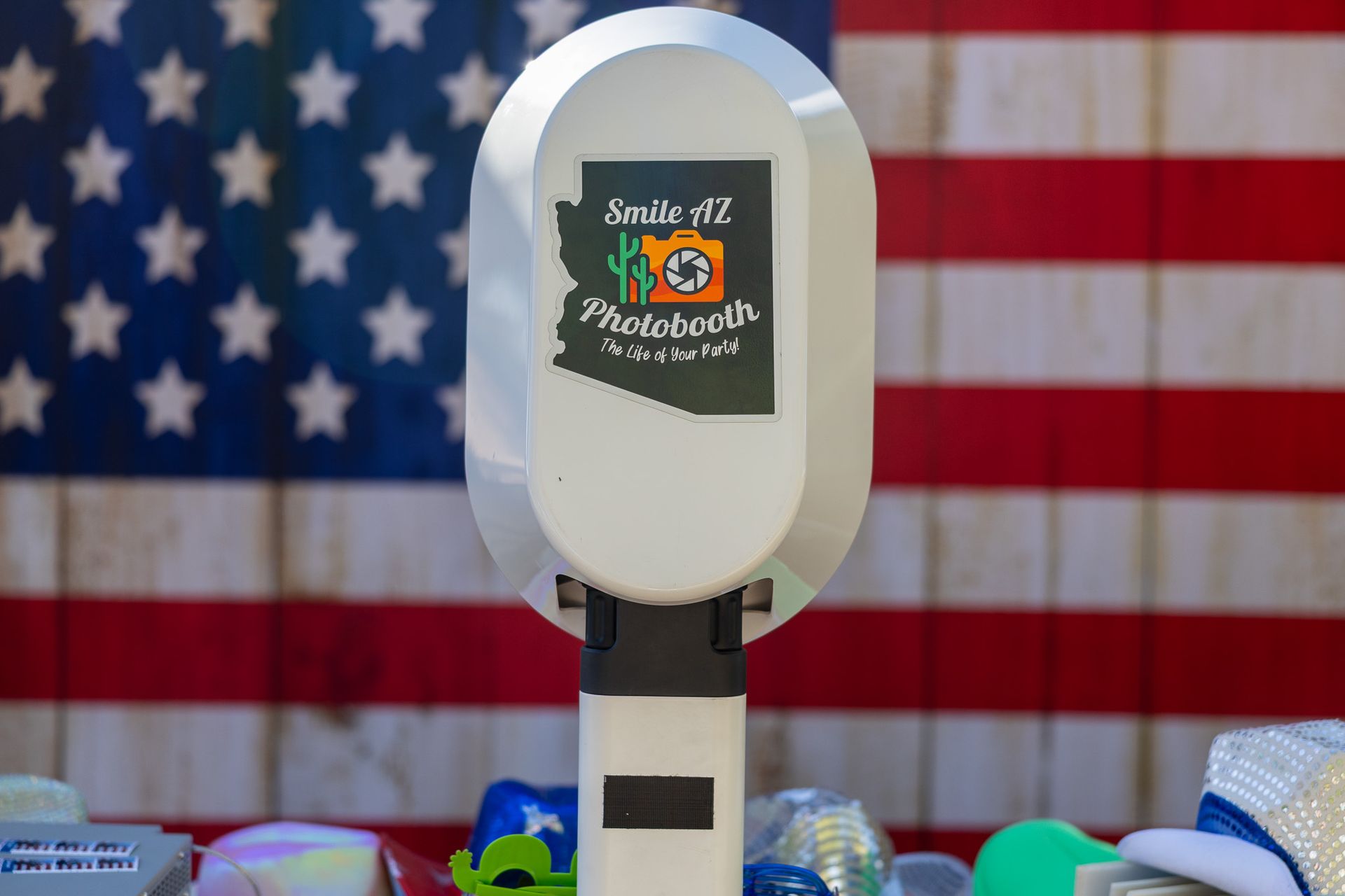 Photo booth against an American flag backdrop, branded