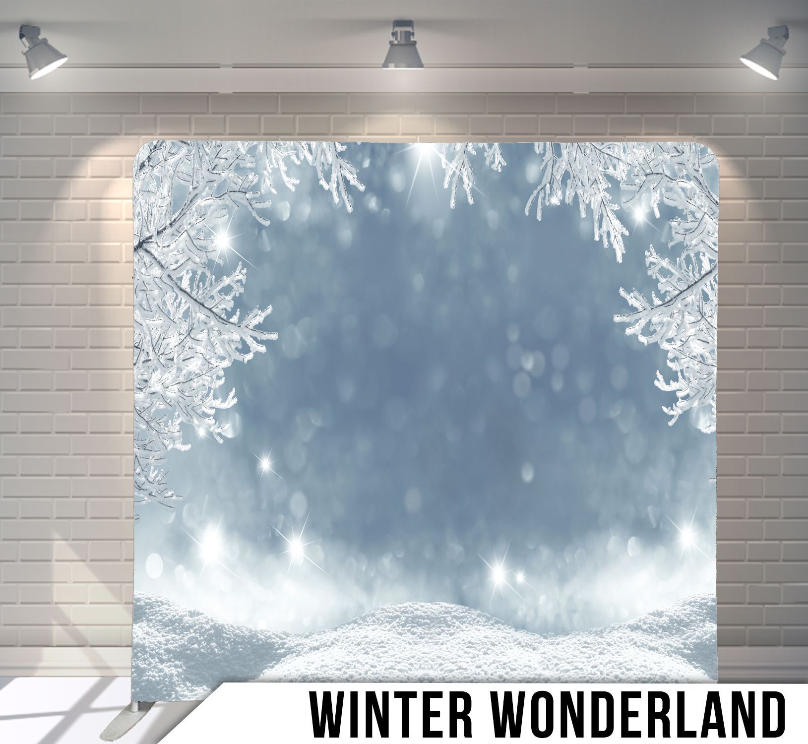 Winter wonderland backdrop with snow-covered branches framing a snowy scene and sparkling lights.