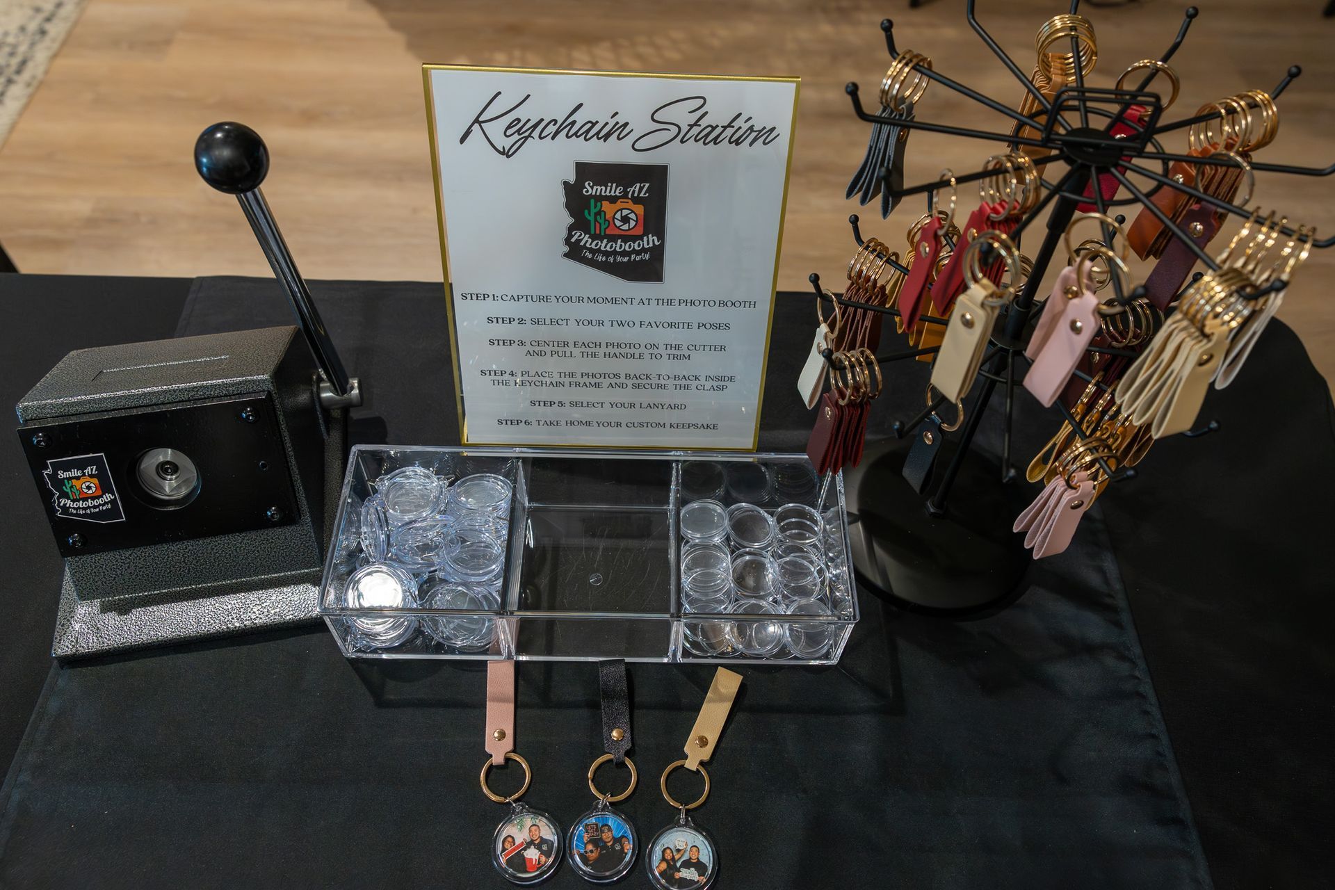 Keychain station display with keychains, a machine, and a sign.