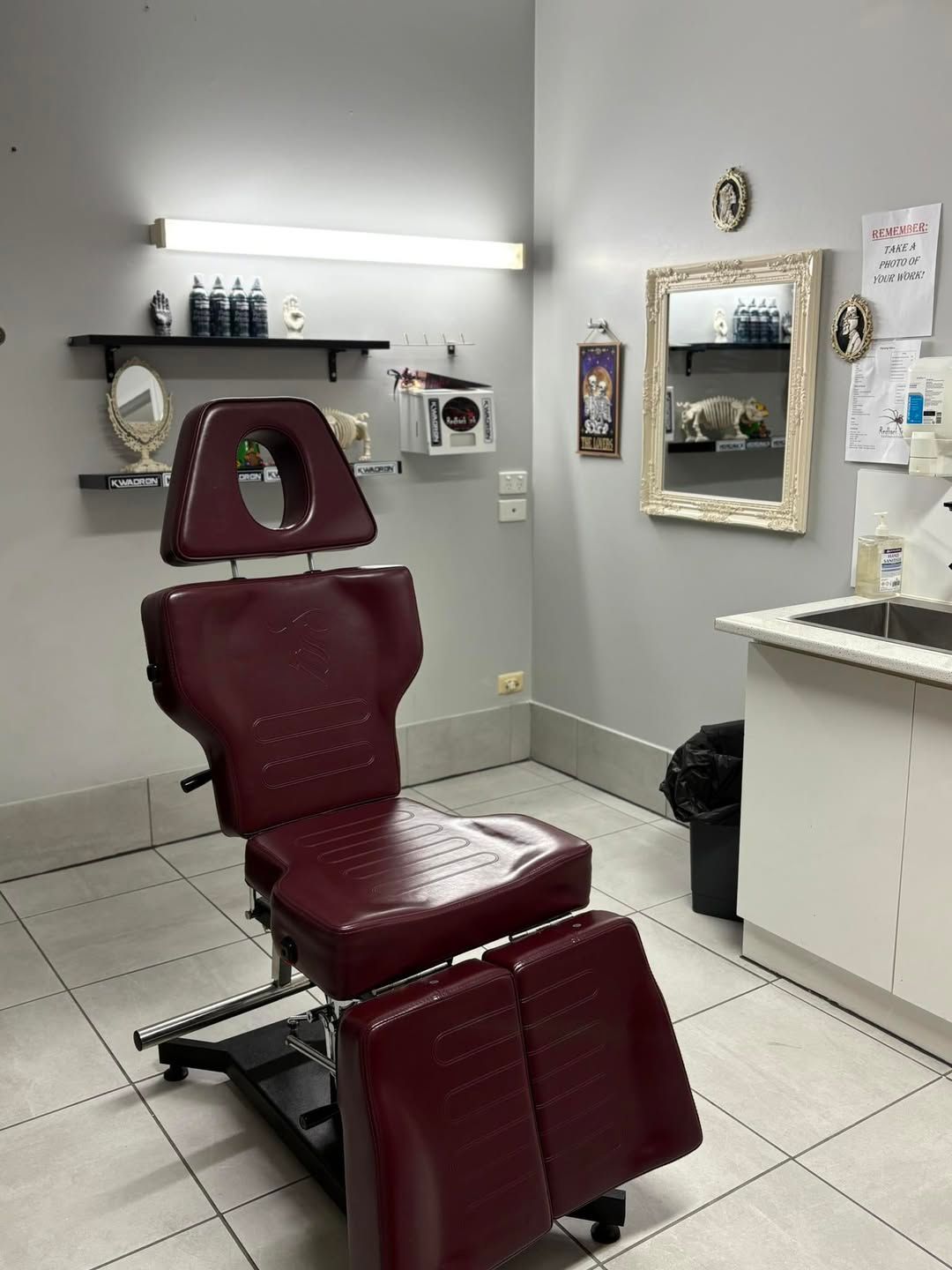 Tattoo Artist's Studio With a Maroon Chair, Supplies, and Mirror — Redback !nk Tattoo Studio in Kawana, QLD