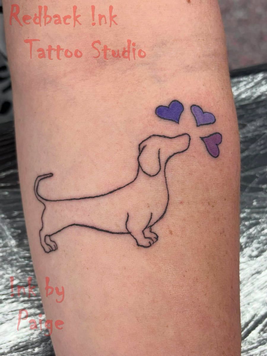 Line-art Dachshund Tattoo Reaching Toward Three Purple Hearts on Skin — Redback !nk Tattoo Studio in Kawana, QLD