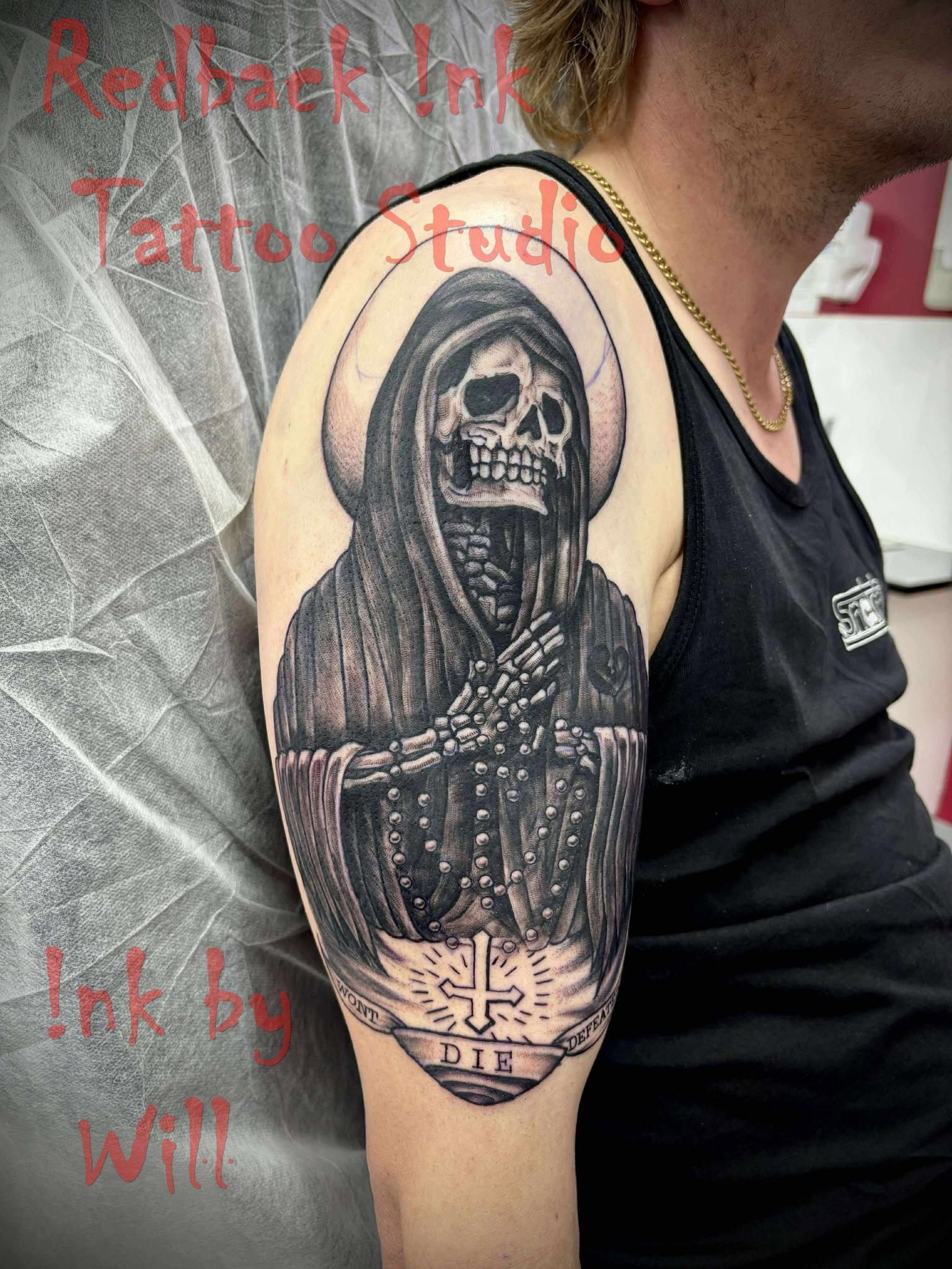 Tattoo of a Hooded Grim Reaper Skeleton With Halo and Cross on a Man's Arm — Redback !nk Tattoo Studio in Kawana, QLD