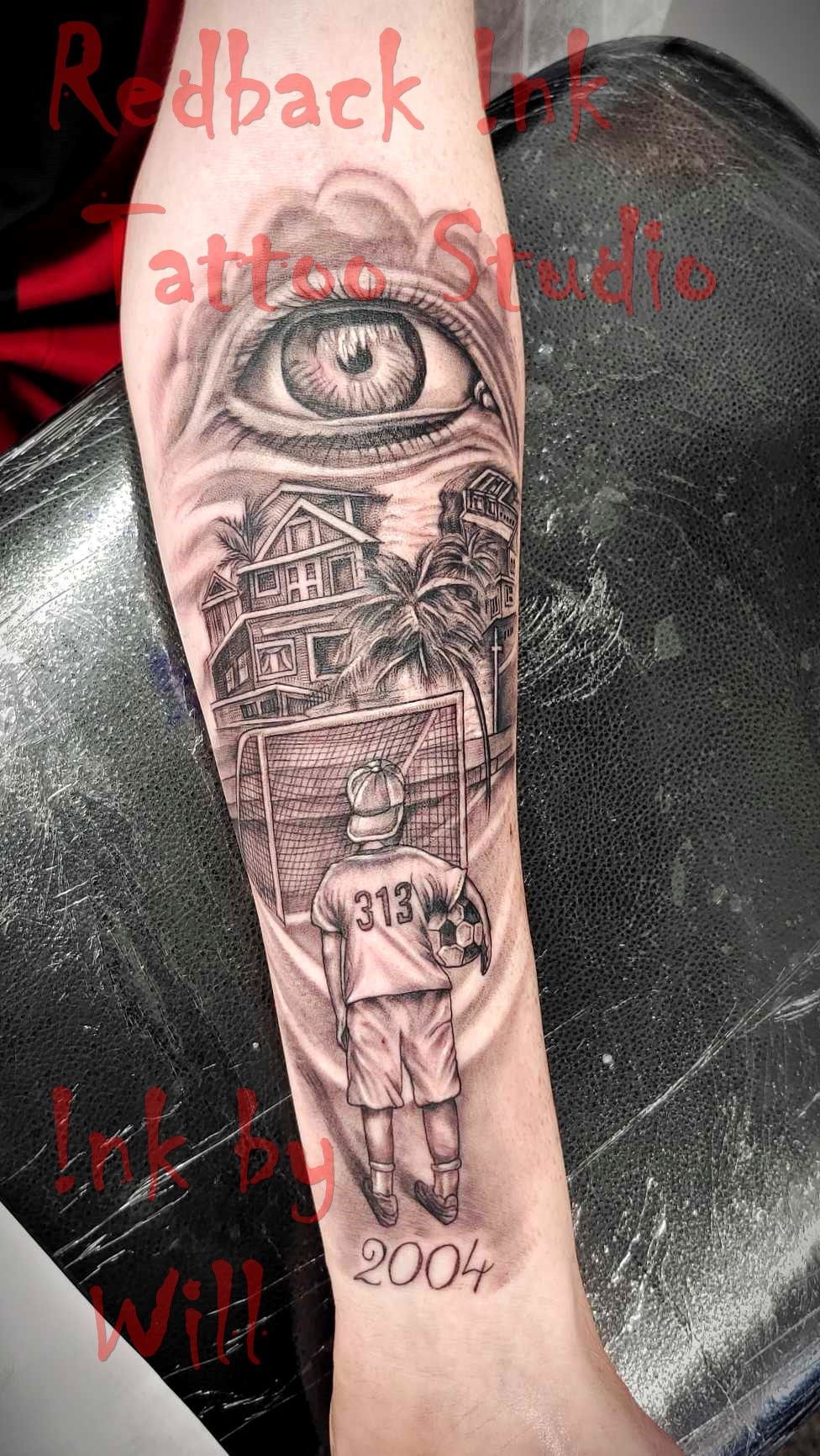 Tattoo of a Soccer Player With a Ball, Eye, Ancient Structures, and the Year 2004 — Redback !nk Tattoo Studio in Kawana, QLD