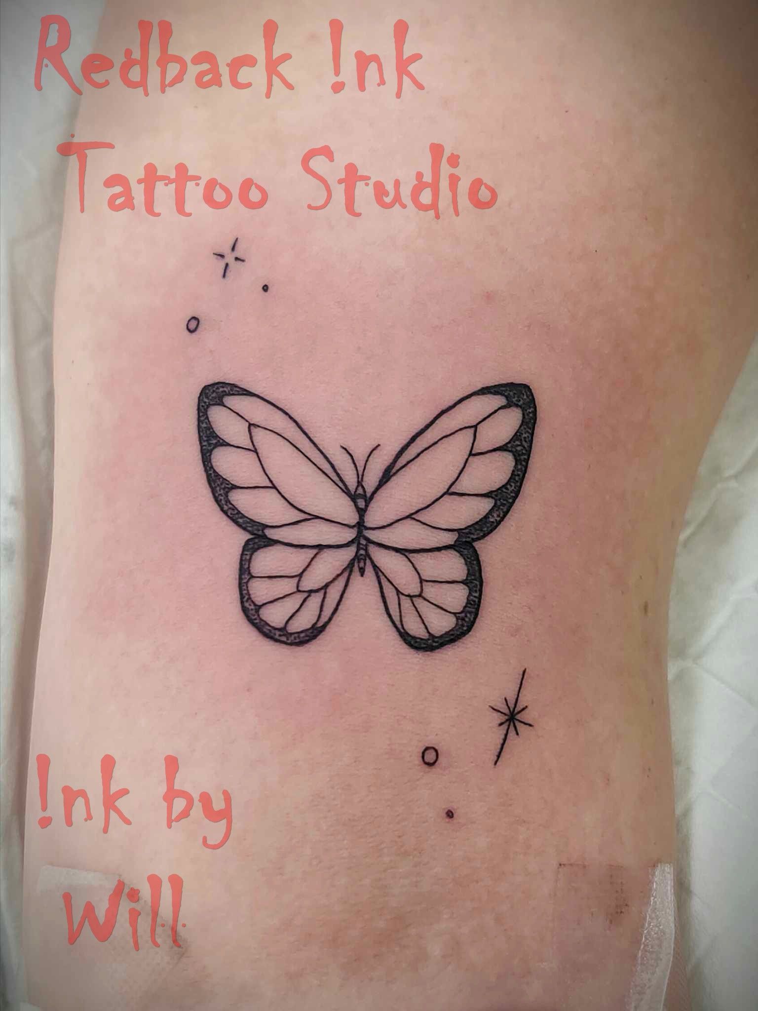 Black Butterfly Tattoo on Skin With Small Stars — Redback !nk Tattoo Studio in Kawana, QLD