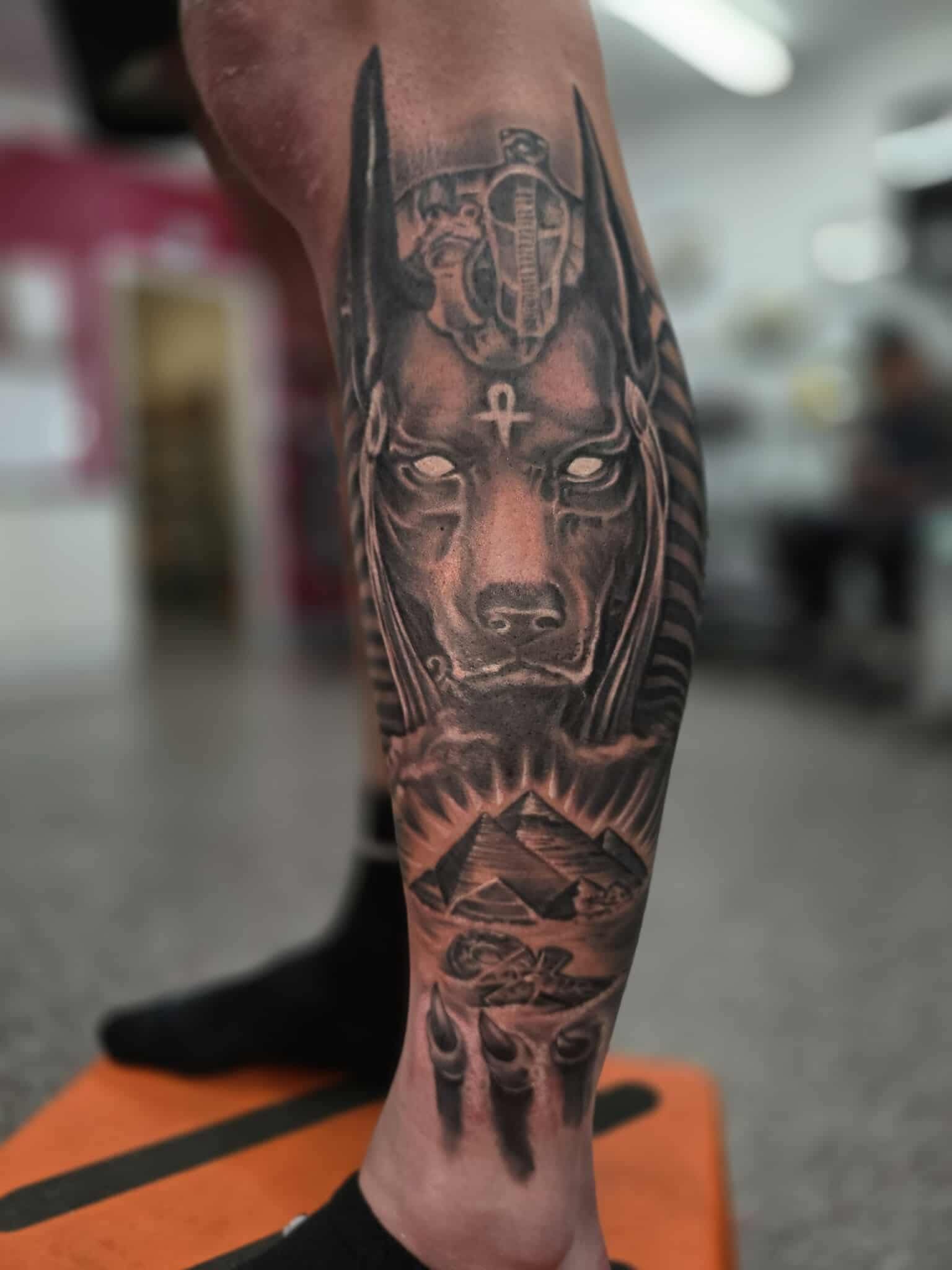 Leg Tattoo of Anubis With Pyramids in a Studio Setting — Redback !nk Tattoo Studio in Kawana, QLD