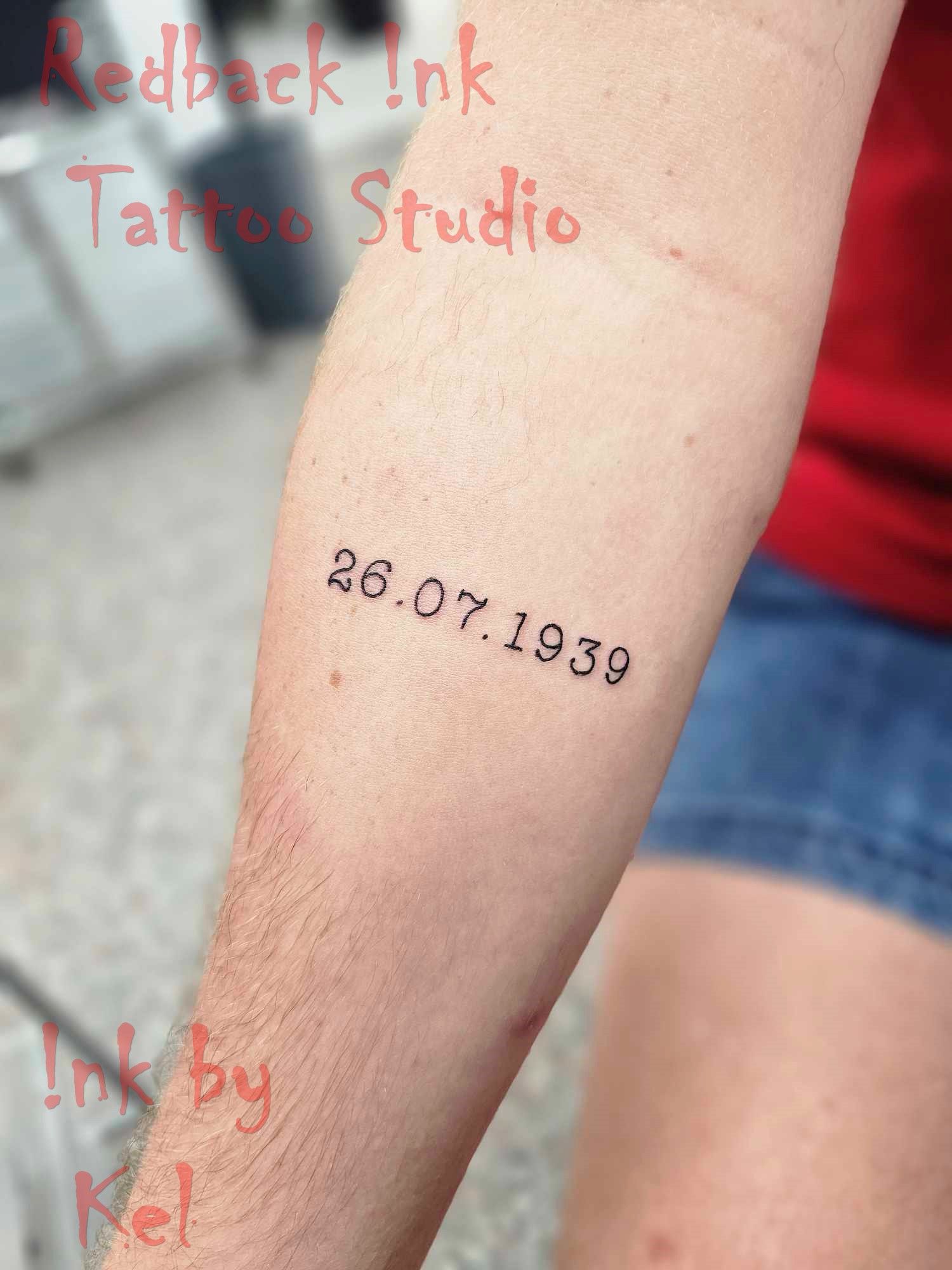 A Person's Forearm With a Tattoo of the Date — Redback !nk Tattoo Studio in Kawana, QLD