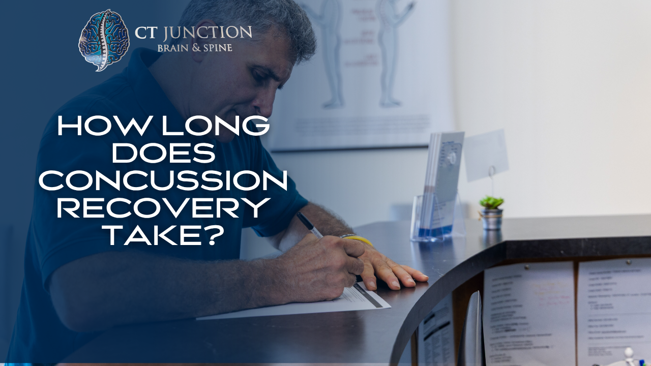 A person fills out paperwork at a front desk in a clinic, with the text