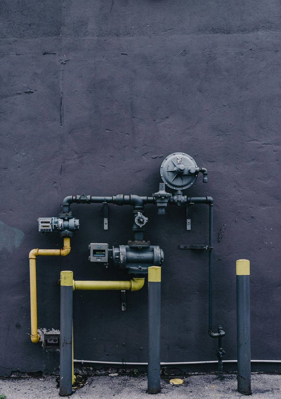 A wall with a bunch of pipes attached to it