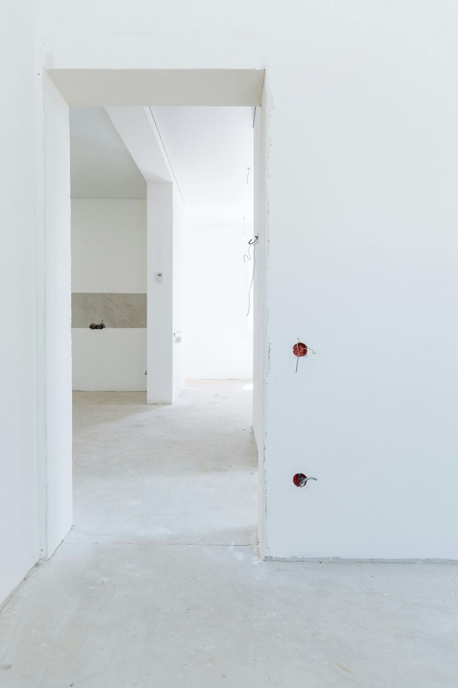 A close up of a door handle on a white door