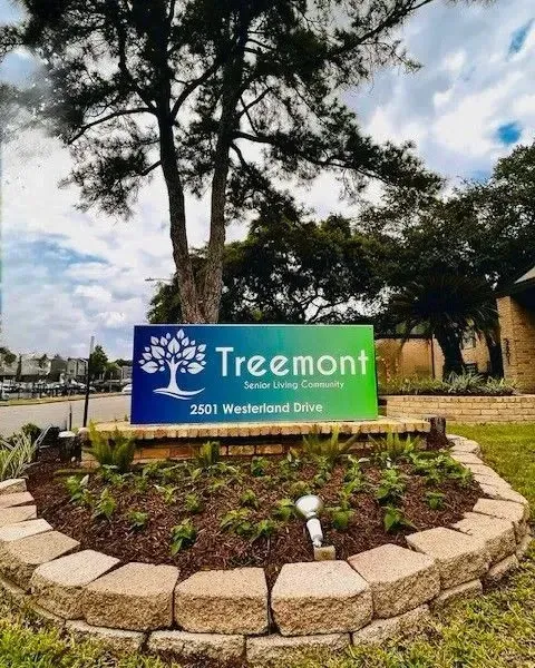 Sign with tree logo and text at Treemont Senior Community in Houston, Texas